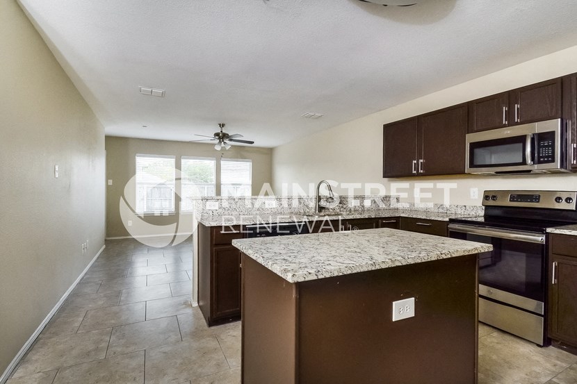 a kitchen with granite counter tops and stainless steel appliances