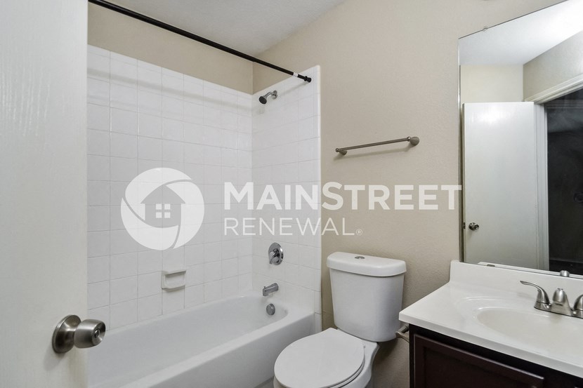 a renovated bathroom with a tub and a sink and a toilet