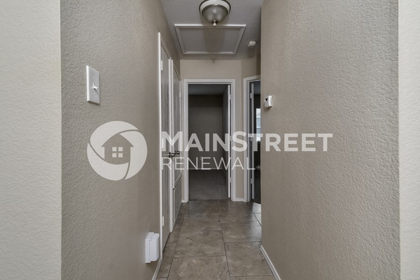 a room with a hallway and a door to a closet