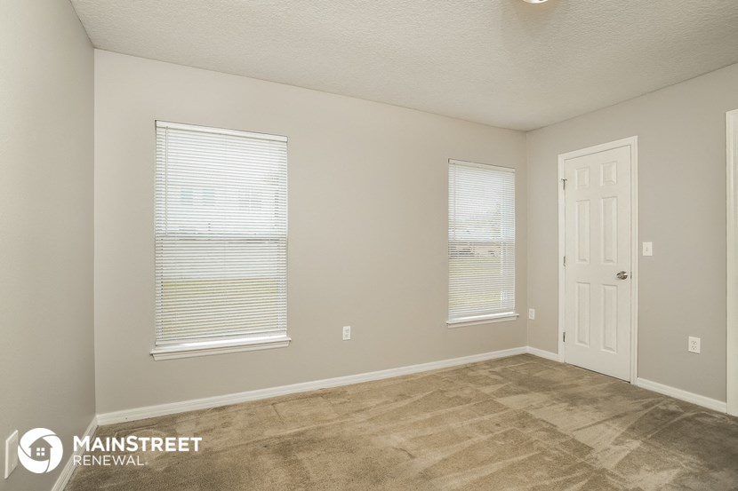 the spacious living room of an apartment at the residence