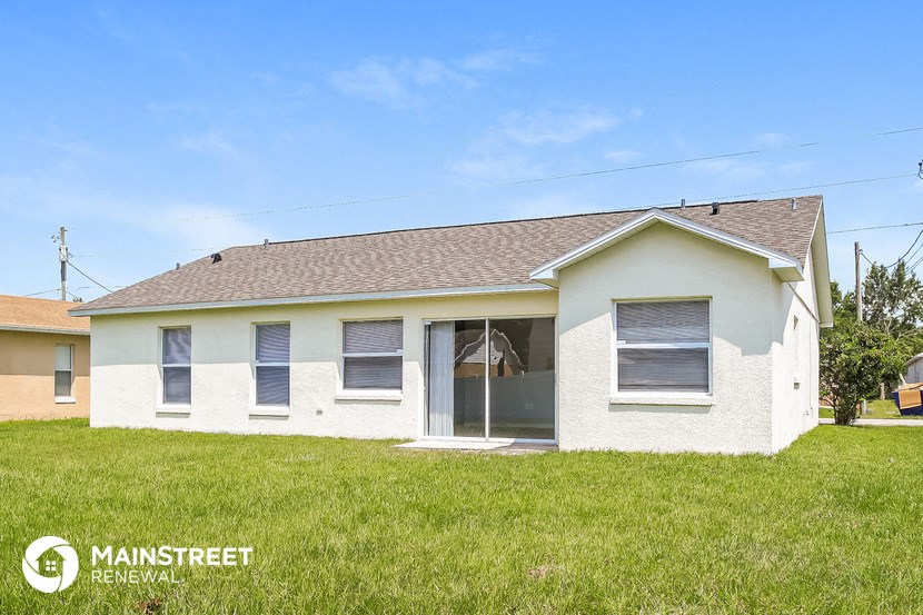 the front view of a white house with a grassy yard