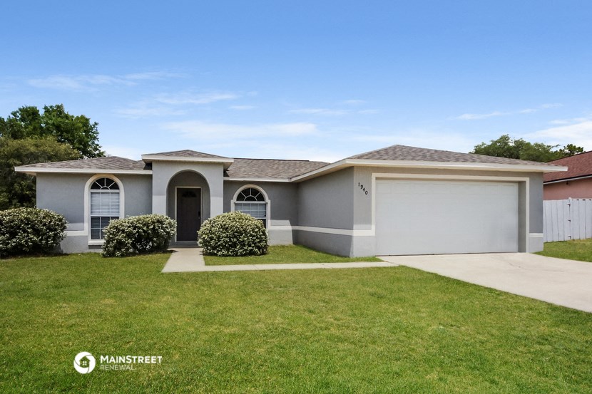 a white house with a lawn in front of it