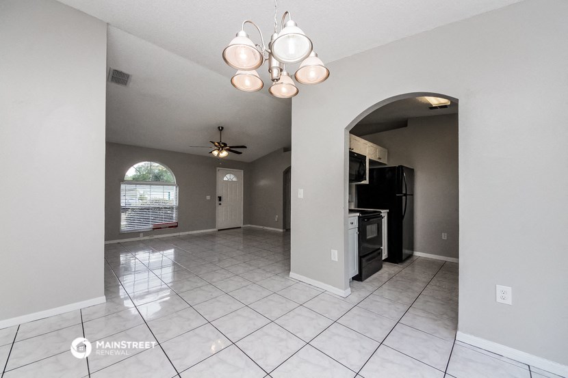 the living room and dining room with the kitchen to the left