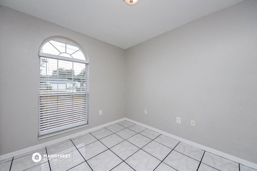 the living room of an empty house with a large window