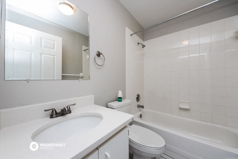 a bathroom with a sink and a toilet and a bath tub