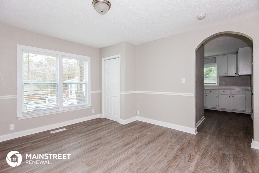 the living room and kitchen of a renovated house