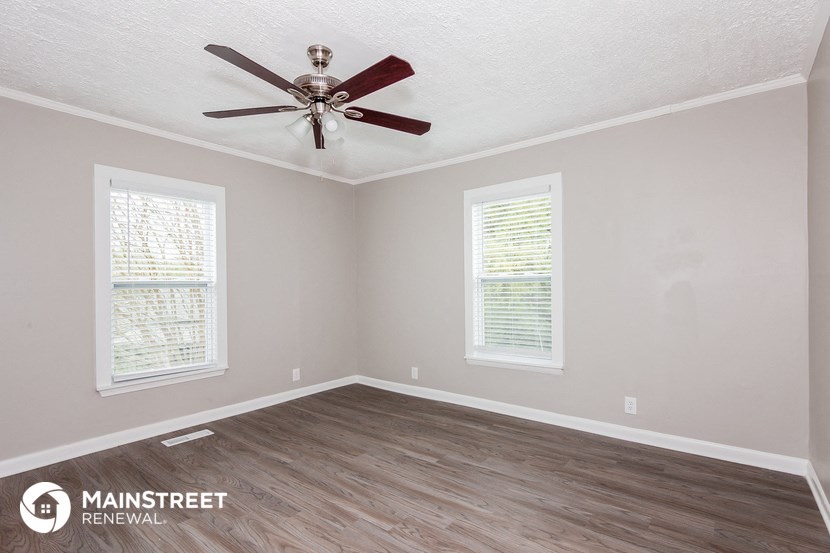 the living room of a new home with a ceiling fan