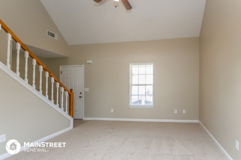 the master bedroom is spacious and has a staircase to the bonus room