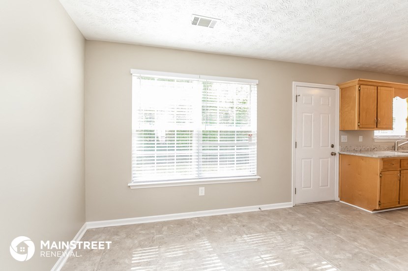 a kitchen with a large window and a white door