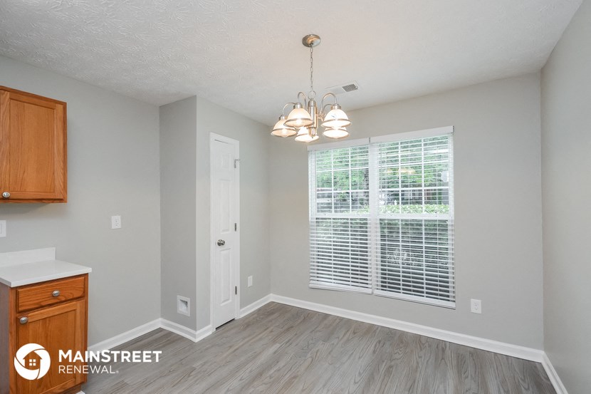 the living room and dining room of a rental house
