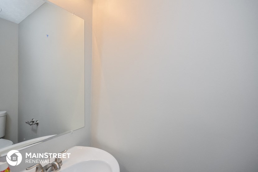 a small bathroom with a sink and a mirror