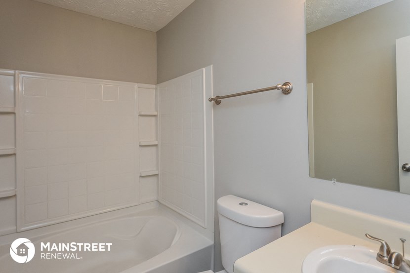 a bathroom with a sink toilet and shower and a tub