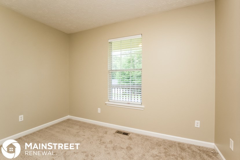 a room with carpet and a window in it
