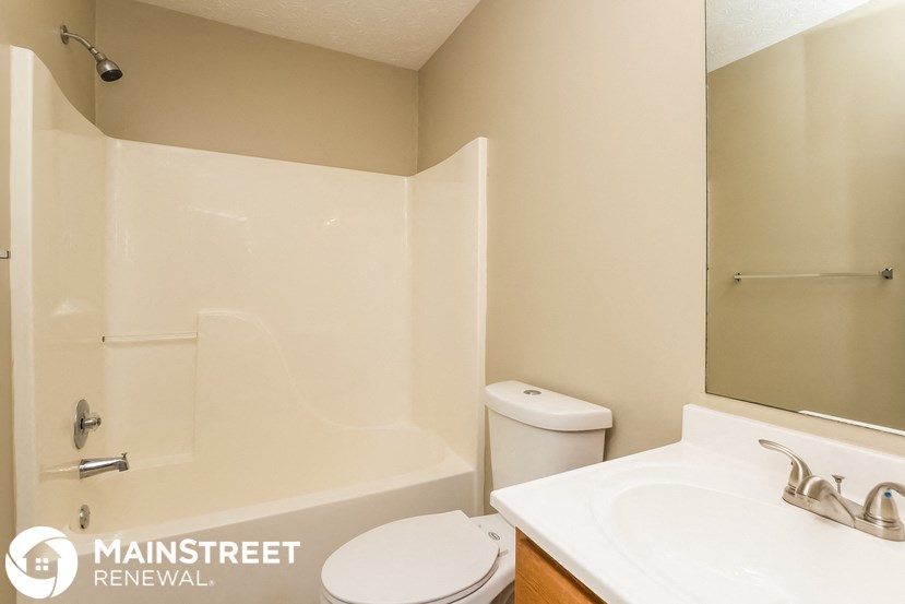 a bathroom with a sink toilet and a shower