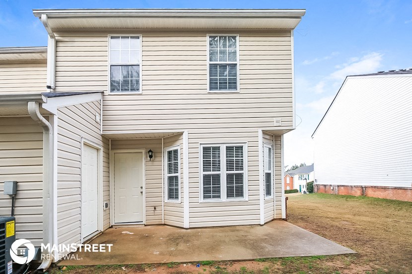 a white house with white siding and a white garage door
