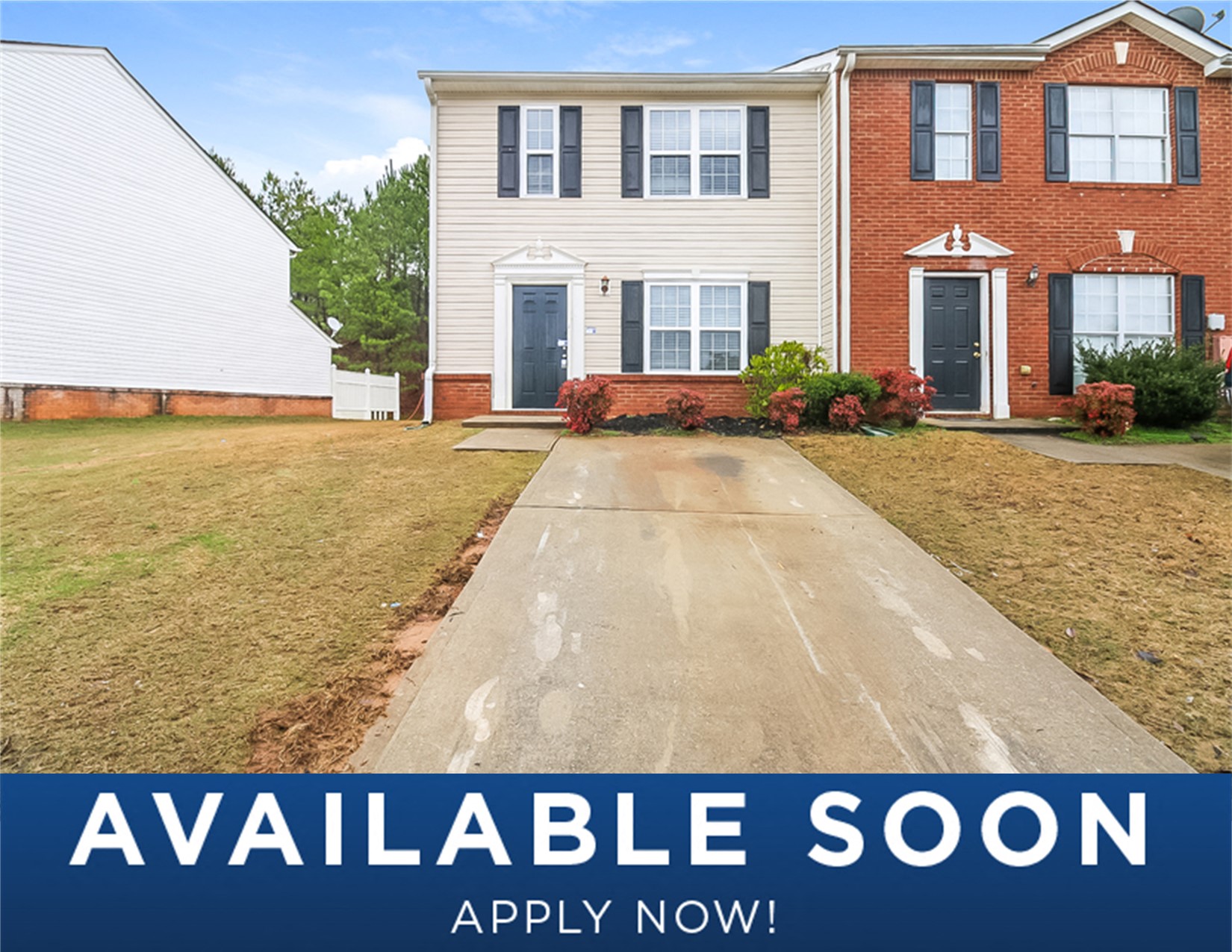 a house with a yard and a driveway in front of it
