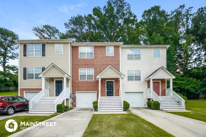 a brick and with stairs and a driveway