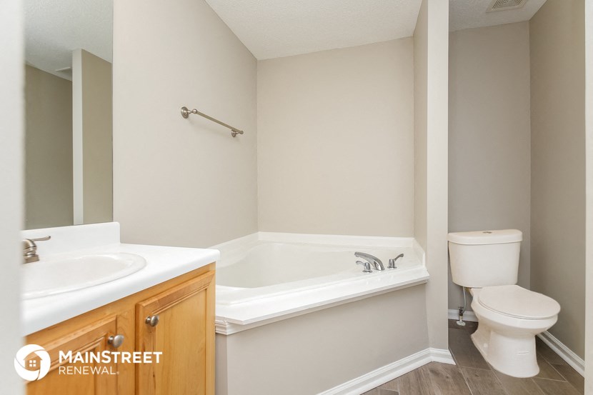 a bathroom with a sink toilet and a bath tub