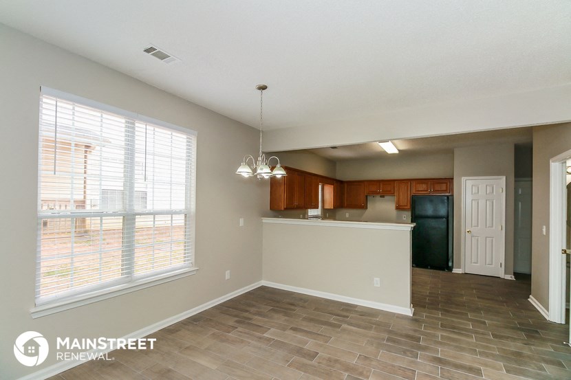 a kitchen with a large window and a counter top in a house