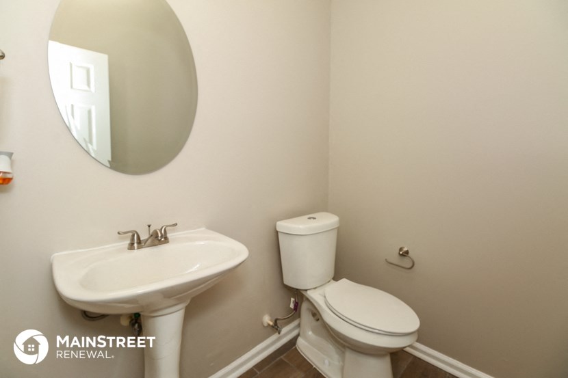 a bathroom with a sink and a toilet and a mirror