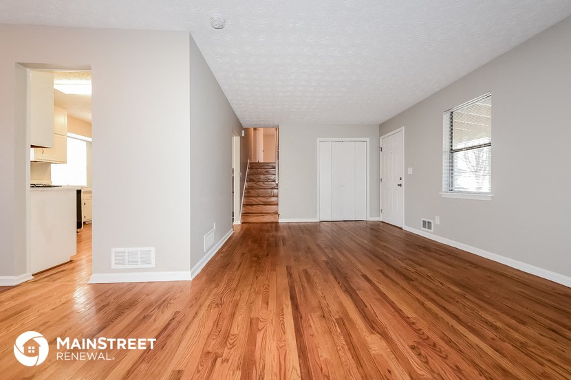the living room and dining room with wood flooring