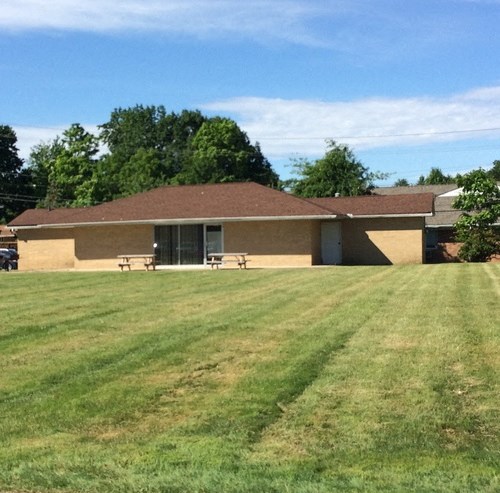 a building with a grass yard in front of it