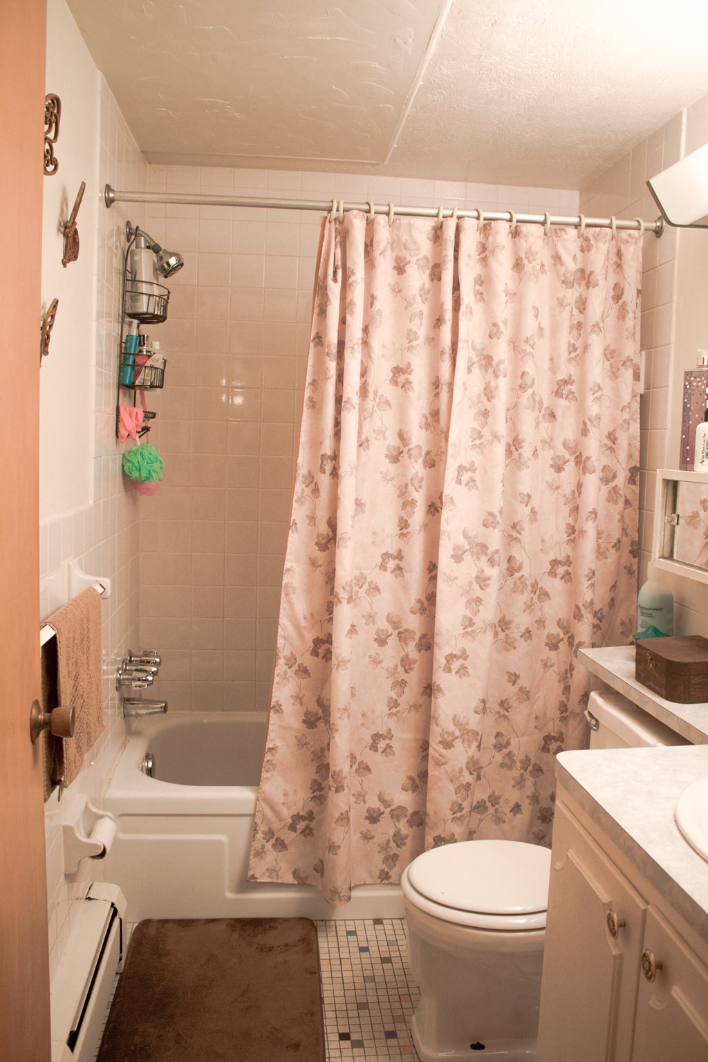 a small bathroom with a shower curtain and a toilet