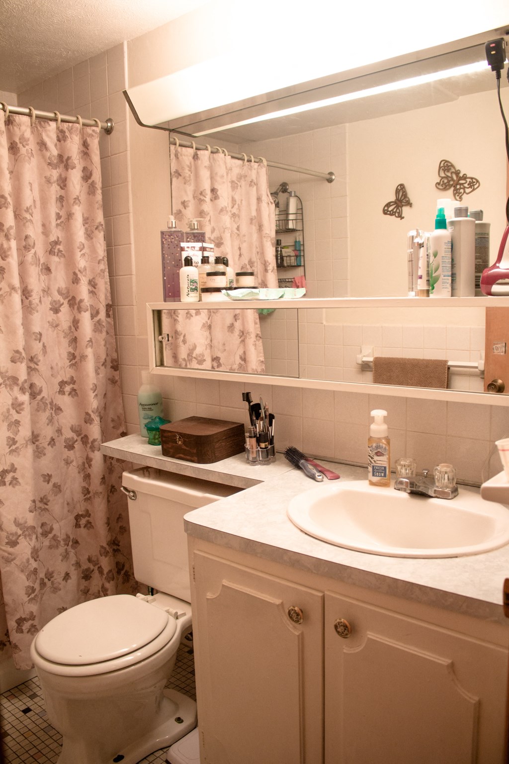 a bathroom with a sink toilet and a shower curtain