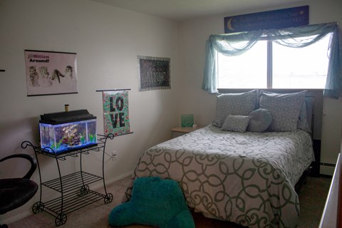 a bedroom with a bed and a fish tank