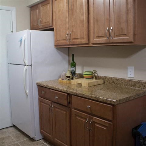 a kitchen with a counter top and a refrigerator