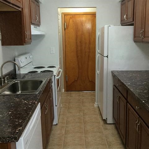 a kitchen with a sink and a refrigerator