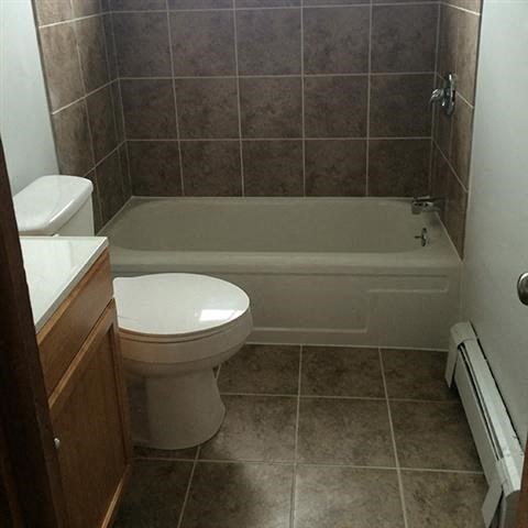 a bathroom with a toilet and a bath tub