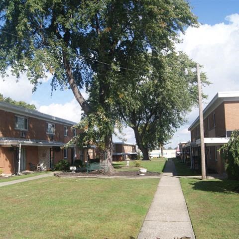 a sidewalk in front of a row of houses