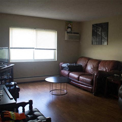 a living room with a leather couch and a coffee table