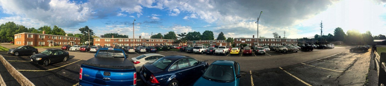 a parking lot full of cars and buildings