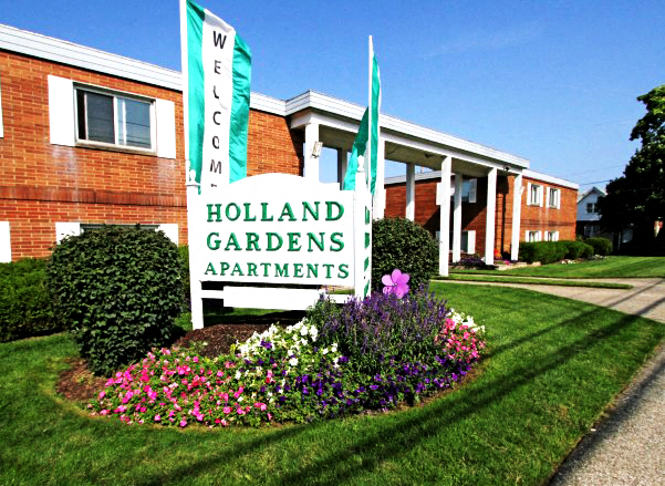 the sign in front of a apartments building