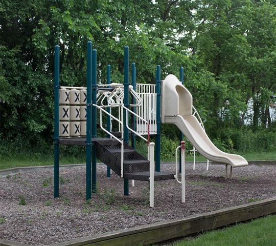a playground with a slide and stairs