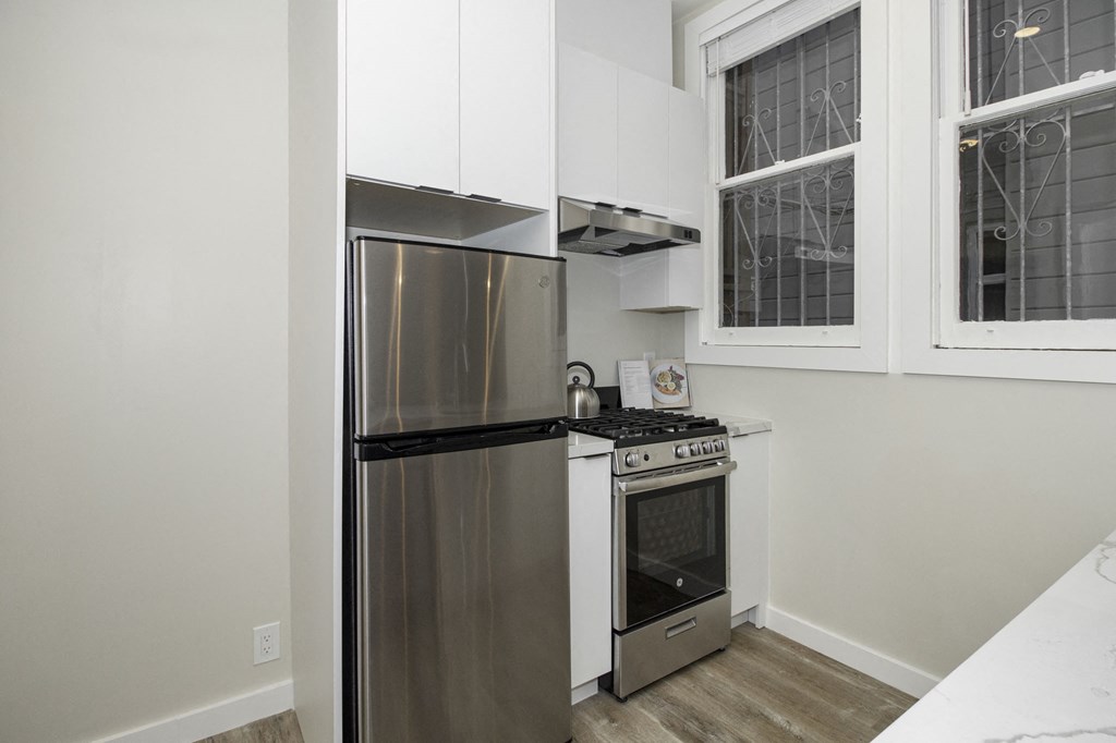 a kitchen with stainless steel appliances and a stove and refrigerator