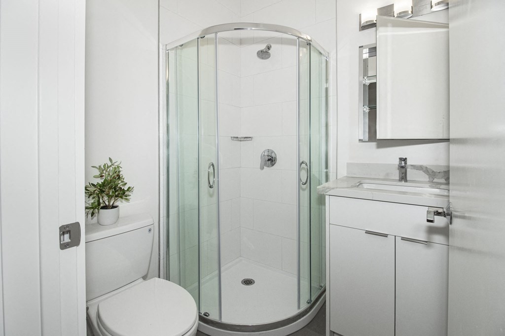 a small bathroom with a shower and a sink