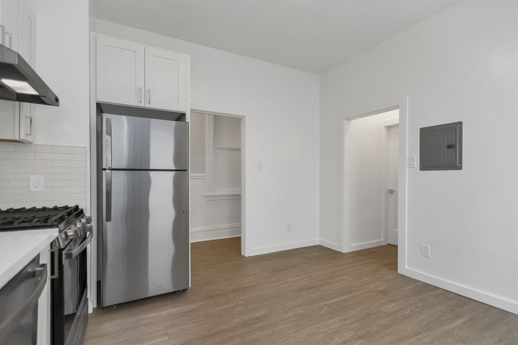a kitchen with stainless steel appliances and white walls