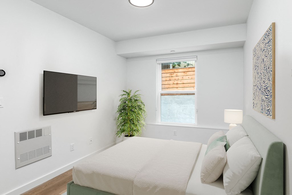 a bedroom with a bed and a tv