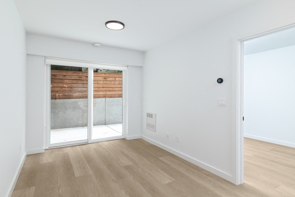a living room with a sliding glass door to a patio