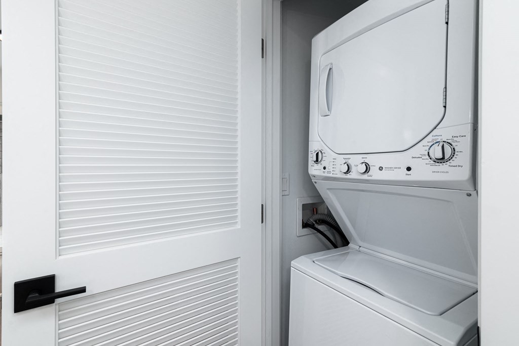 a laundry room with a washer and dryer on the door