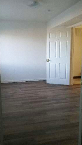 an empty living room with a white door