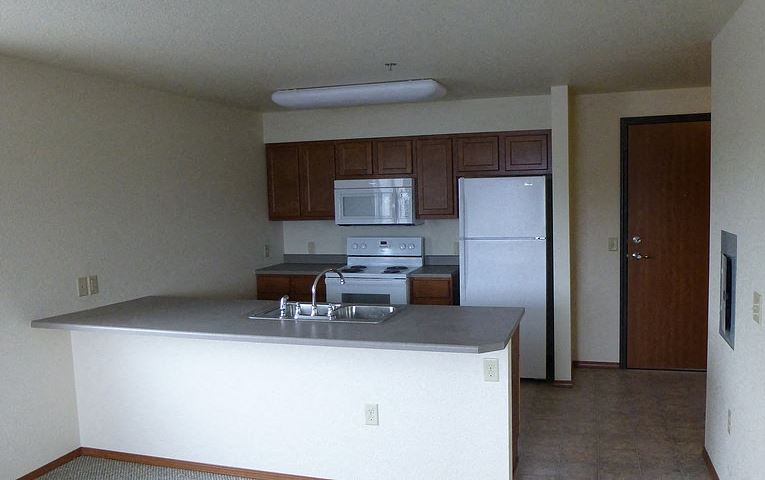 Image of stove, microwave, sick, refrigerator, cabinets, and counter space - Photo Gallery 1