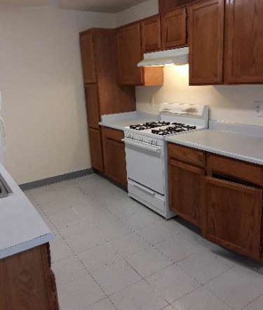 a kitchen with a stove and a white floor