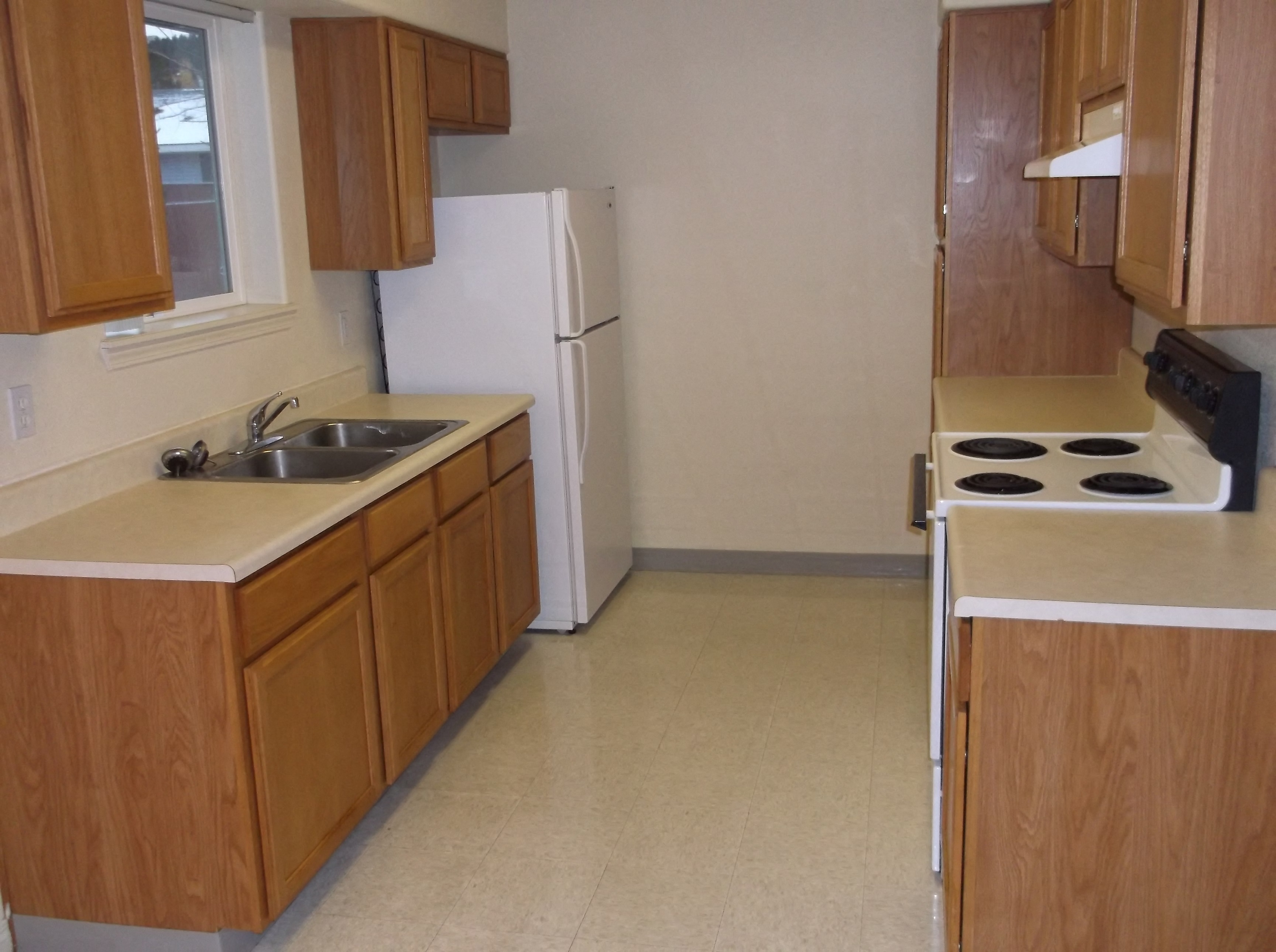 a kitchen with a sink and a refrigerator