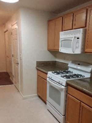 Kitchen Image of stove, microwave, cabinets, and counter space