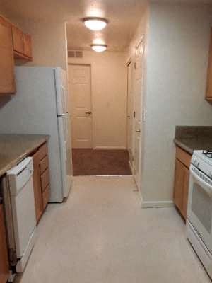 Kitchen Image of stove, microwave, dishwasher, refrigerator, cabinets, and counter space