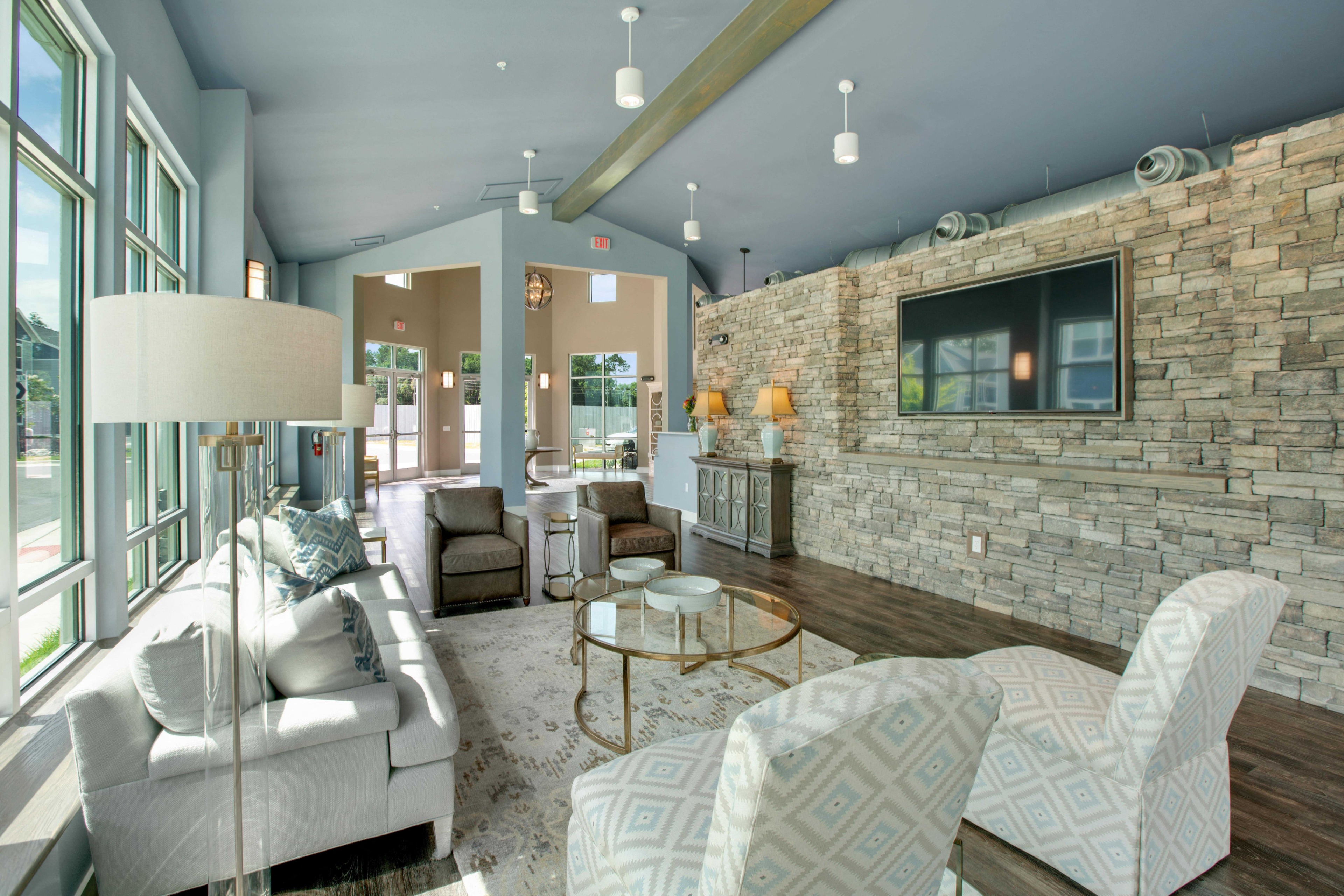 a living room with blue walls and a brick wall